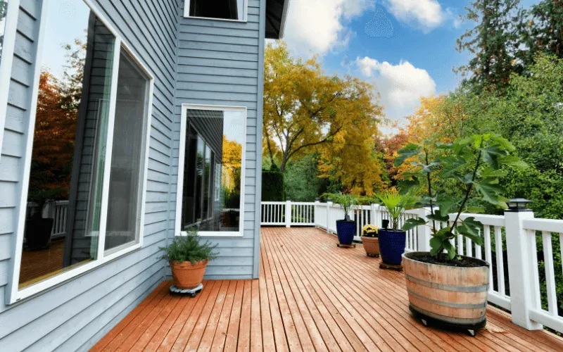 beautiful-long-wood-deck-stained-with-white-ballusters-and-railings_result